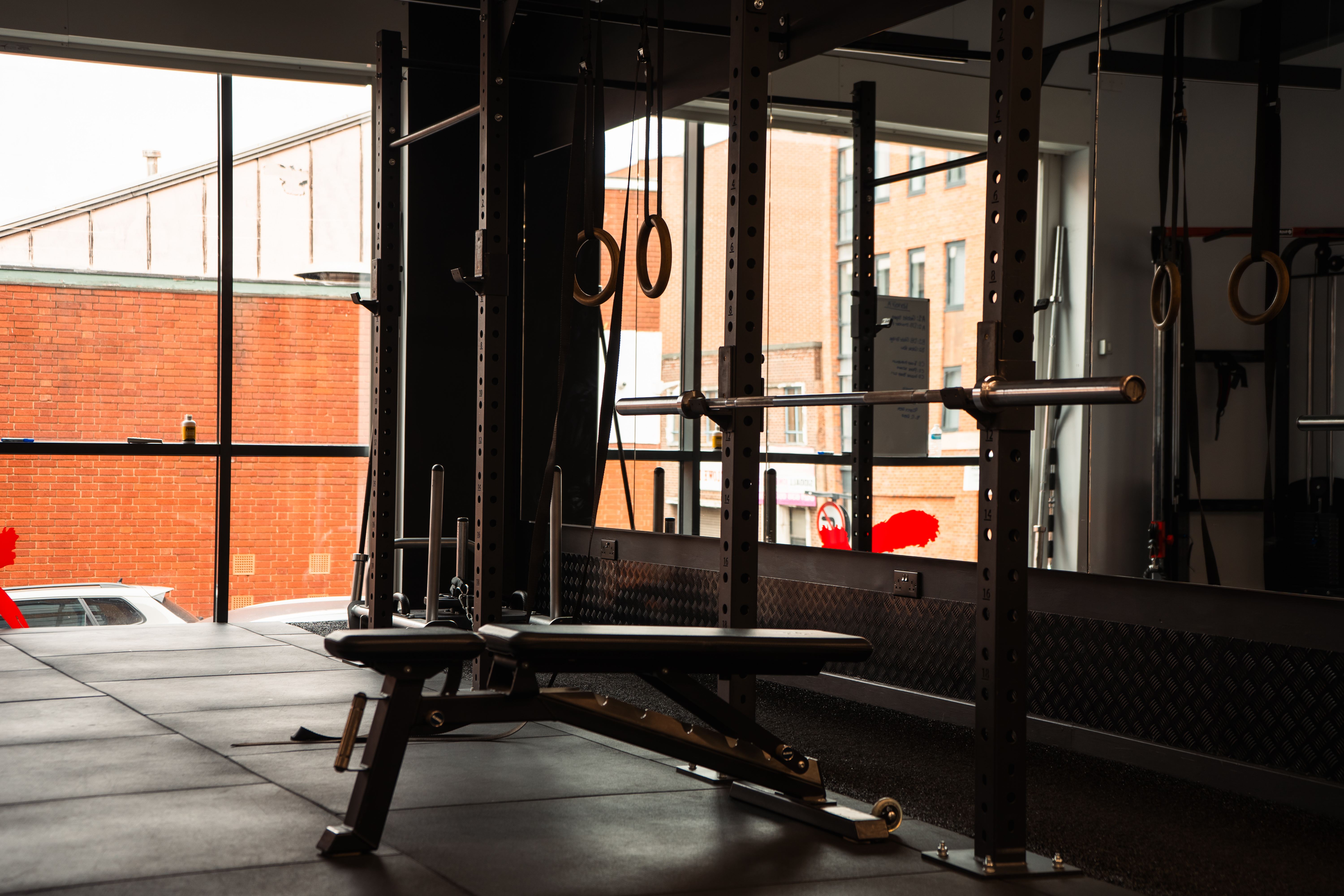 KBX Gym Interior with bench press and Olympic rings